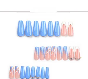 Detailed view of long coffin press-on nails in blue hues with rhinestones and patterns