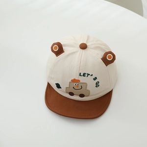 Detail view of baby baseball cap featuring cartoon car embroidery and cute 3D ear accents