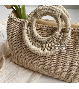 Dettaglio della trama di una borsa in paglia con manici circolari per lo stile estivo