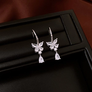 Detailed view of silver butterfly earrings with sparkling cubic zirconia teardrops