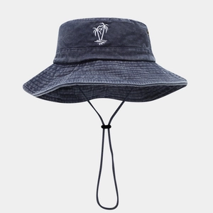 Close-up of coconut tree embroidery on washed blue outdoor sun hat with windproof cord