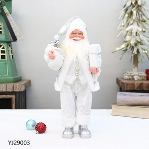 Detail of Santa Claus figurine in silver sequins holding a white gift box for Christmas