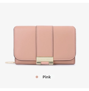 Detail of pink leather wallet with litchi texture and gold Classic & Modern plaque