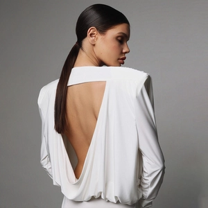 White backless long sleeve bodysuit for women featuring a deep V-cut and soft draped fabric