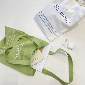Detail view of cotton canvas tote bag featuring Harmony and MFS typography on the surface