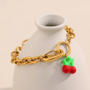 18K gold plated thick chain bracelet featuring a colorful cherry pendant on a white vase