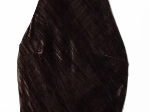 Close-up of premium dark brown velvet fabric with vertical texture on midi dress