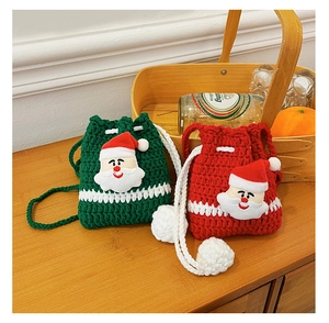 Detail of handmade crochet Christmas reindeer bags with soft knit texture and festive colors
