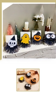 Close-up of Halloween hair clips featuring skull, ghost, and pumpkin with mesh detail