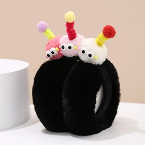Detail of black plush earmuffs featuring colorful monster dolls and spiral antennas