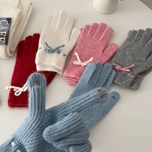 Detail showing knit gloves with fingertip openings and small bow design in multi-colors