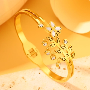 Elegant gold-plated bangle featuring white clover flower and leaf charms with sparkling zircon
