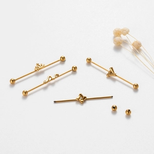 Golden stainless steel industrial barbell earrings with crown and snake designs