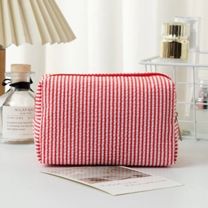 Red and white vertical striped seersucker makeup bag with a durable zipper closure