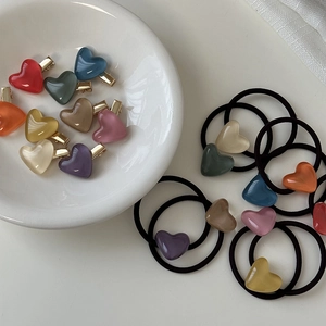 Detail of jelly heart hair clips and elastic bands in assorted macaron colors