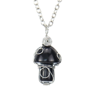 Macro view of hand-woven silver wire wrap on a black agate mushroom pendant necklace