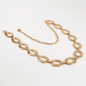 Elegant gold metal chain belt with polished oval links on a clean white background