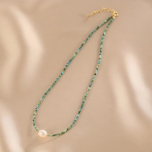 Double layered necklace with turquoise beads and a white freshwater pearl centerpiece