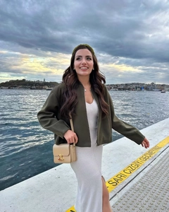 Deep green utility zip jacket paired with a white slim fit knit dress for women