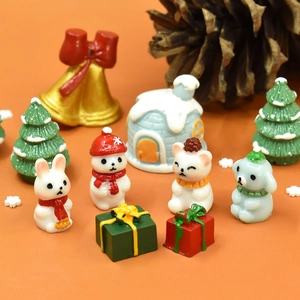 Resin Christmas miniature figurines with snowman and reindeer on orange festive backdrop