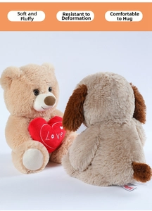 Close-up of soft plush teddy bear holding a red love heart with embroidered Love lettering