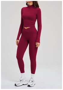 Detail showing cross V-cut high waistband and deep red professional yoga fabric texture