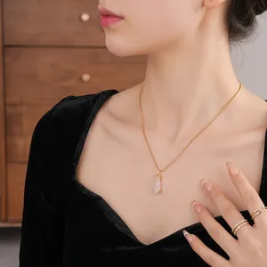 Elegant gold-plated chalcedony eggplant necklace on model with black velvet outfit