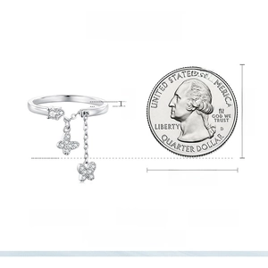 Size comparison of S925 silver butterfly ring with cubic zirconia next to a coin