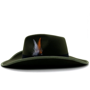 Detail of dark green felt fedora featuring a black ribbon band and decorative natural feathers
