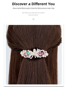 Macro shot of rose gold floral hair clip with crystals and colored resin on brown hair