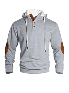 Detail view of grey quilted hoodie showing elbow patches and front button closure