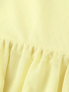 Detail of light yellow knit fabric showing soft pleated texture and fine stitching
