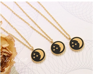 Detailed macro view of triple gold chains with star and moon medallions in retro style