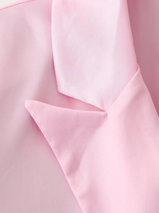 Close-up of elegant pink satin suit notched lapel showing smooth fabric texture and sheen