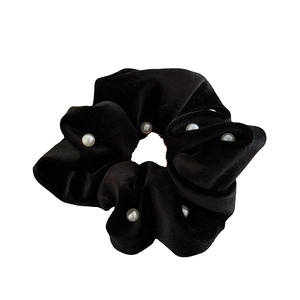 Elegant black velvet scrunchie with large pearls on a clean white background