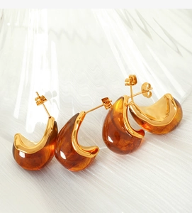 Detailed close-up of French vintage amber resin earrings with 18K gold-plated steel