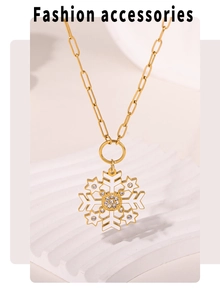 Macro detail of gold snowflake pendant with white enamel and sparkling zircon stones