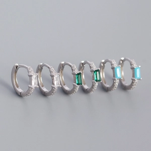 Detail of s925 silver hoop earrings featuring emerald, blue, and clear rectangular zircons