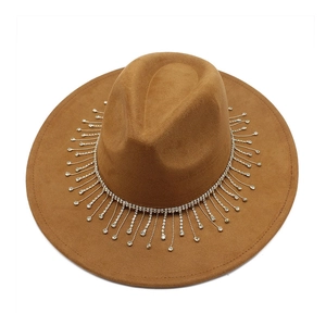 Detailed close-up of brown suede fedora with sparkling silver rhinestone tassel trim