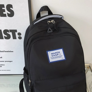 Japanese style black nylon school backpack with large capacity and front zip pocket