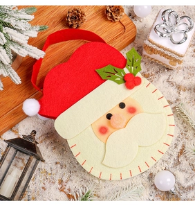 Close-up of Santa felt gift bag with textured fiber detail in a festive snowy setting