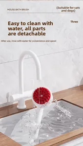Detail of detachable mouse bath brush being rinsed under a faucet with water splashes