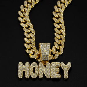 Close-up of golden money letter pendant on iced-out Cuban link chain with crystals