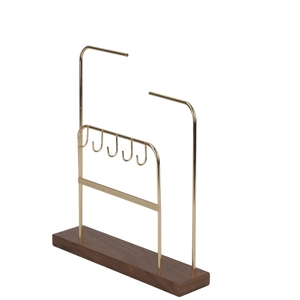 Detail of gold metal jewelry organizer with dark wood base and double-tier hooks