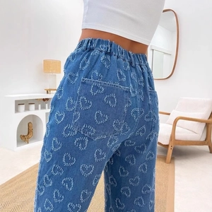 Women's blue denim straight jeans with heart pattern fringe and elastic waist back view