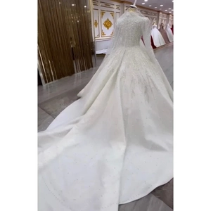 Elegant white long-sleeved bridal gown with luxury beaded lace and grand cathedral train
