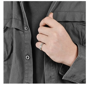 Detail of two-tone gold and silver stainless steel ring with micro-pave on pinky finger