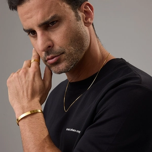 Close-up of a man wearing a gold 18K stainless steel snake chain and jewelry set
