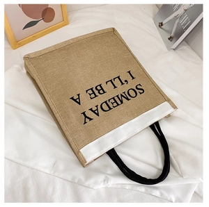 Detail of jute tote bag with cotton rope handles and Someday printed slogan text