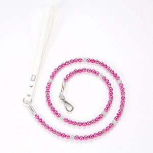 Detail of pink pearl pet leash with white leather handle and silver metal hook clasp